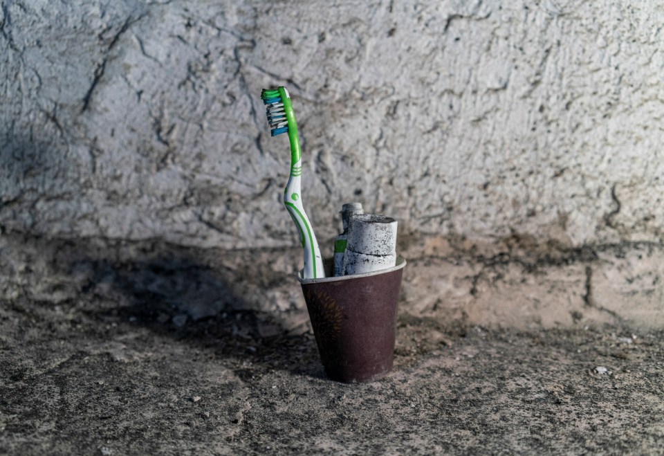 A toothbrush and paste are seen inside an office building used as a torture chamber