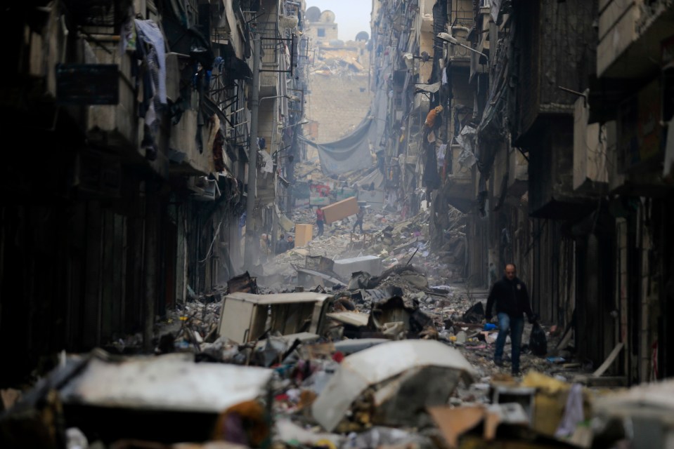 Residents pick their way through the destruction in Aleppo, Syria