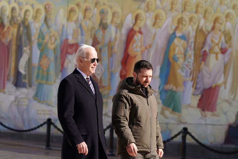 The duo walk in front of a mural of angels near St Michael's Cathedral