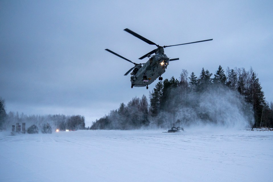 A British Chinook helicopter whips up a snowstorm as it comes in to land