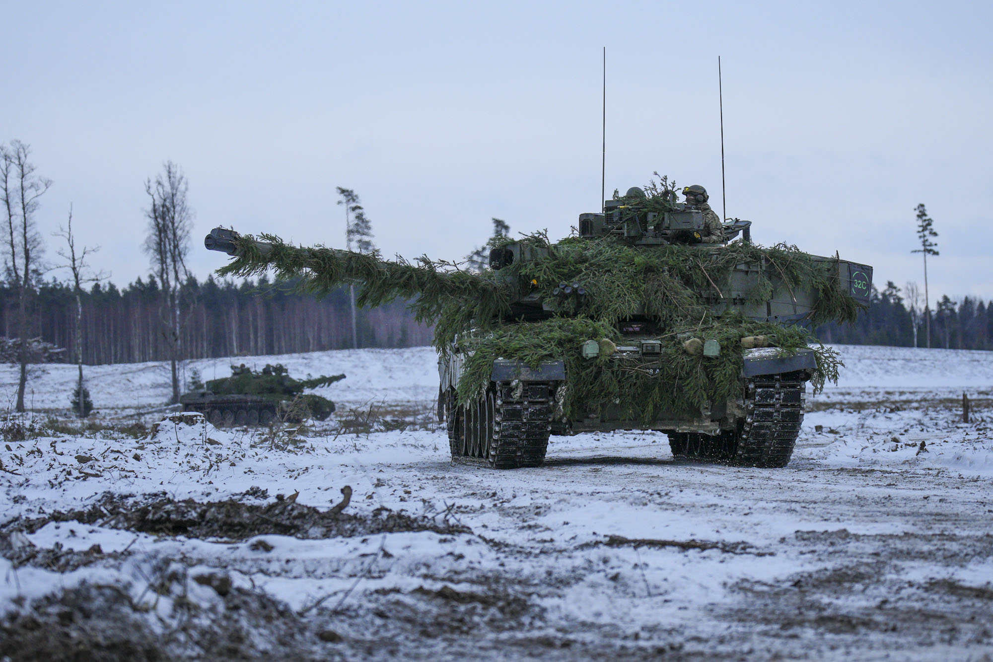 British tanks rumble through the snowfields as part of the drills