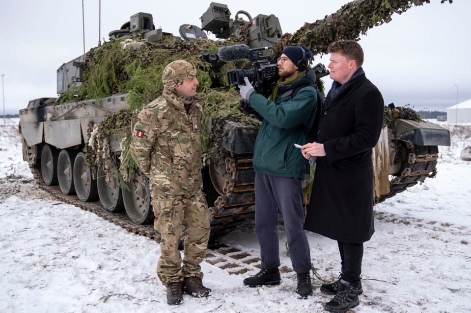 Sun men Anthony Blair, right, and Max Molyneux speak to Major Nick Bridges on the ground in Estonia