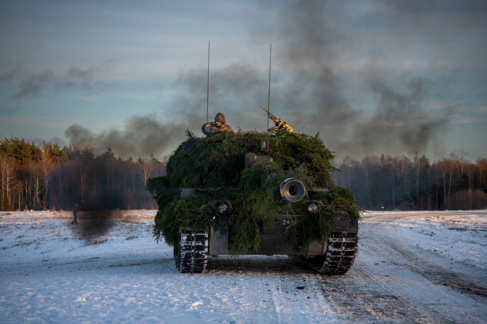 A tank crew advancing ground during an exercise