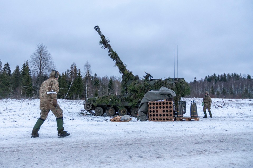 Gunners preparing to load and fire the A90 Howitzer