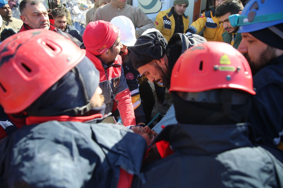 A woman is rescued from the rubble of a building in Malatya, Turkey