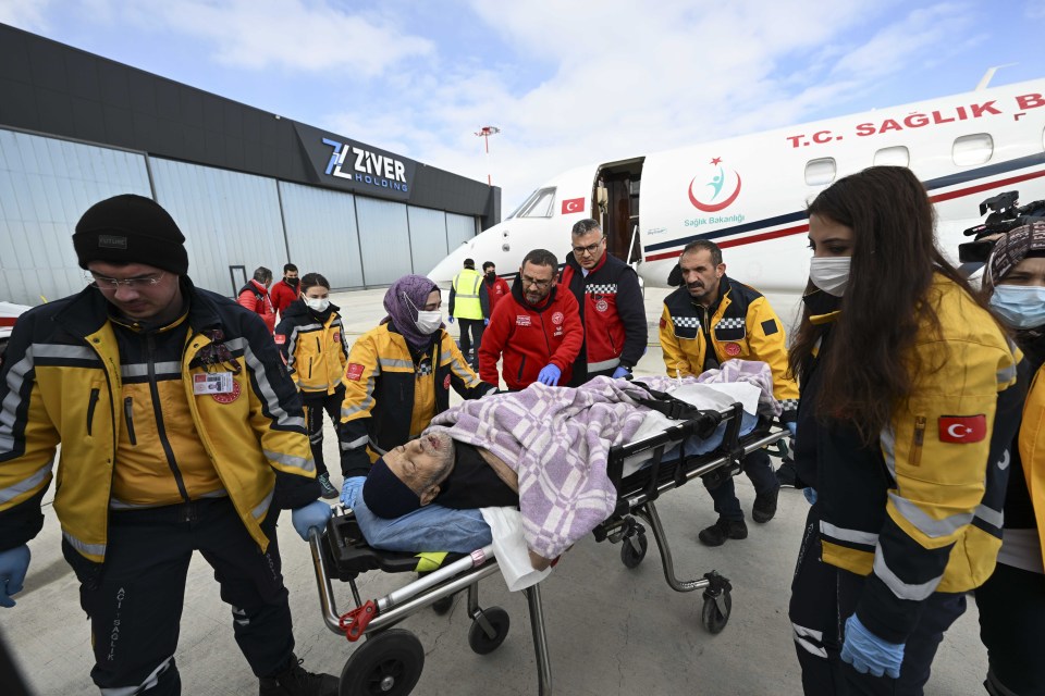 Injured people, rescued from under rubble of collapsed buildings in Adana, are brought for treatment