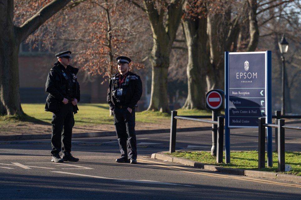 Cops stand guard by the school entrance