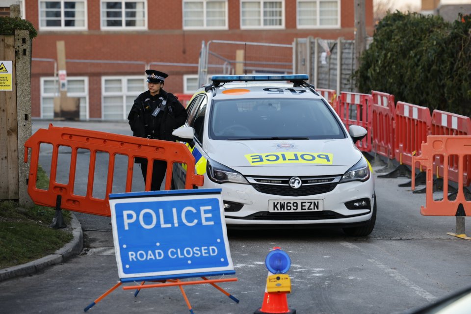 Police continue to guard the entrance to Epsom College in Surrey