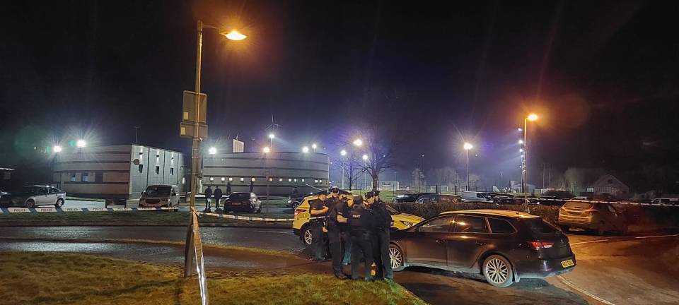 Police at the scene where an off-duty police officer was shot