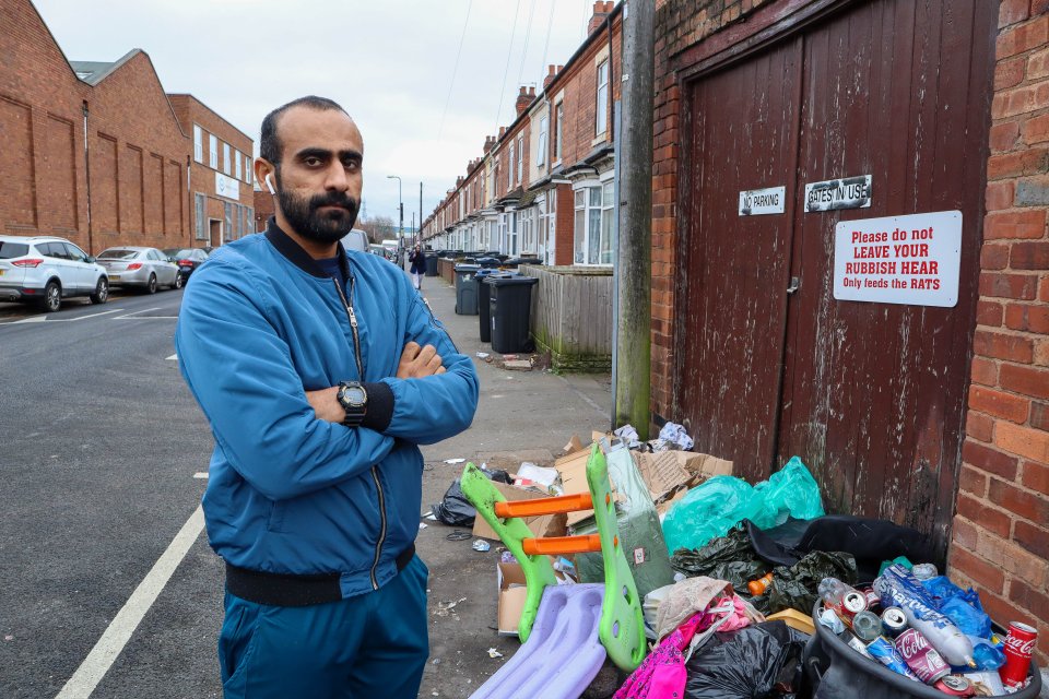 Rafay Mhmed is pictured near some of the overflow of the rubbish pile near his home