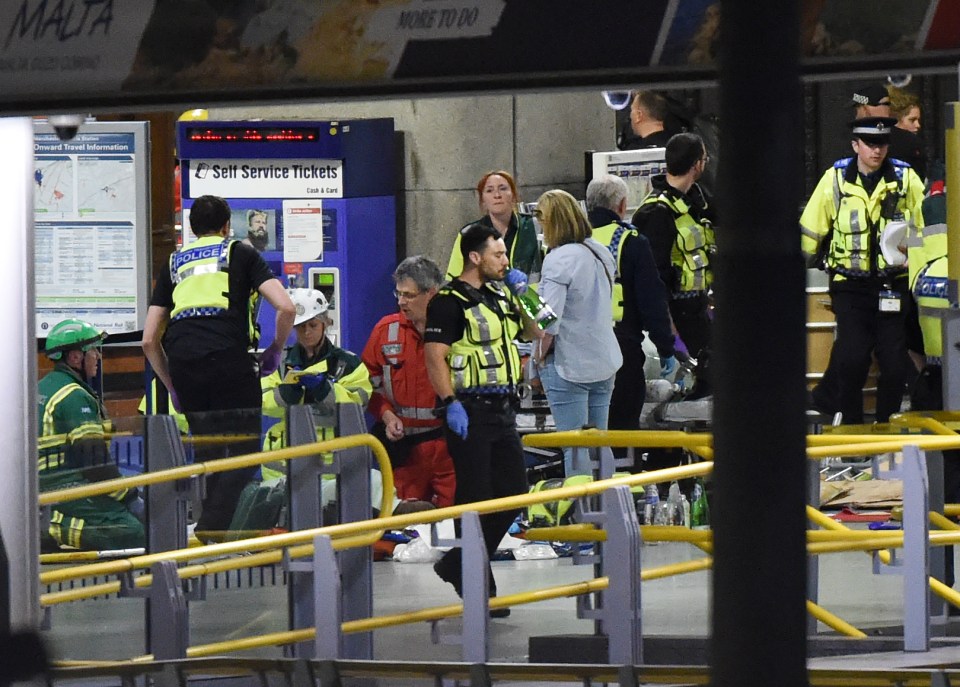 Injured victims are treated on the platform at Victoria Station in Manchester city centre after the bombing of Manchester Arena