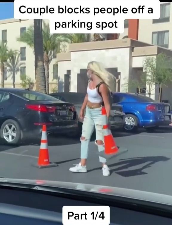 A woman blocks their car off using parking cones to swoop in and steal the space