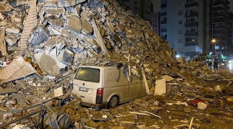 A vehicle is buried beneath debris after the two earthquakes in Turkey