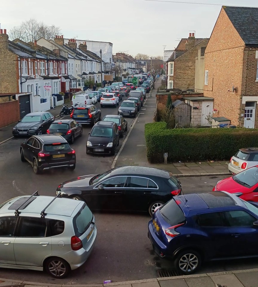 Traffic piled up as it filtered around the blockage through the narrow street