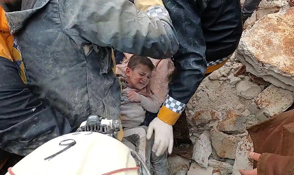 A child is pulled from the rubble in rebel-held Idlib in Syria