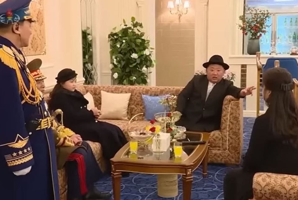 Kim and his daughter enjoy a selection of cakes and juice during the military parade