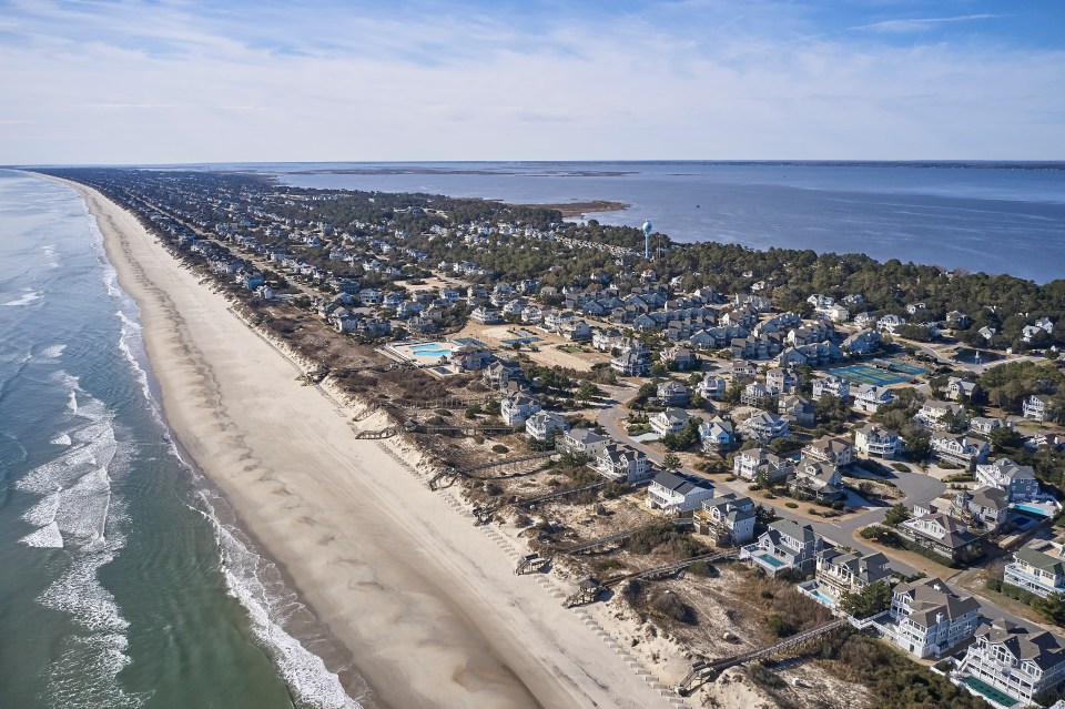 an aerial view of a beach with houses on it