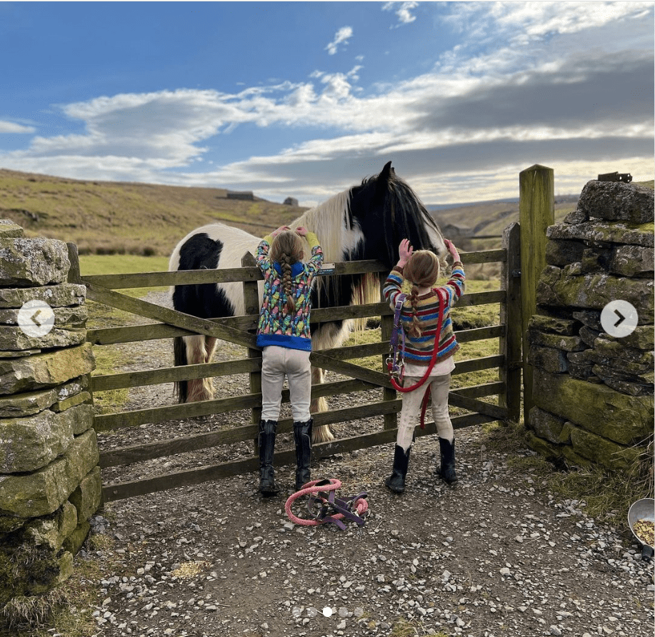 Amanda's children are seen caring for the horses at the stables