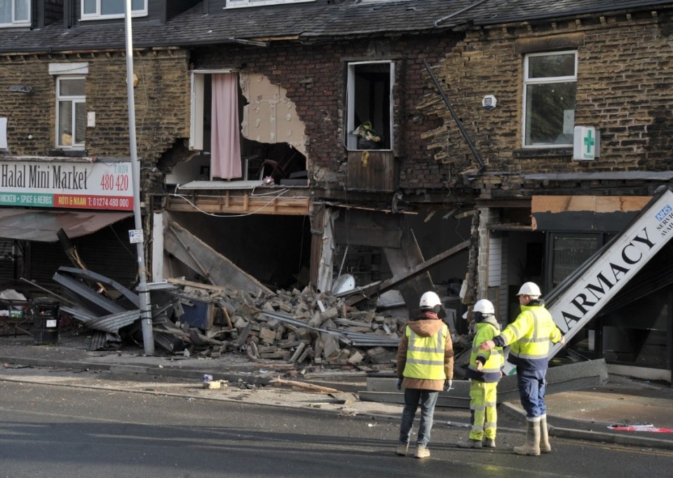 Shocking photos show the aftermath of two police cars crashing into a row of shops