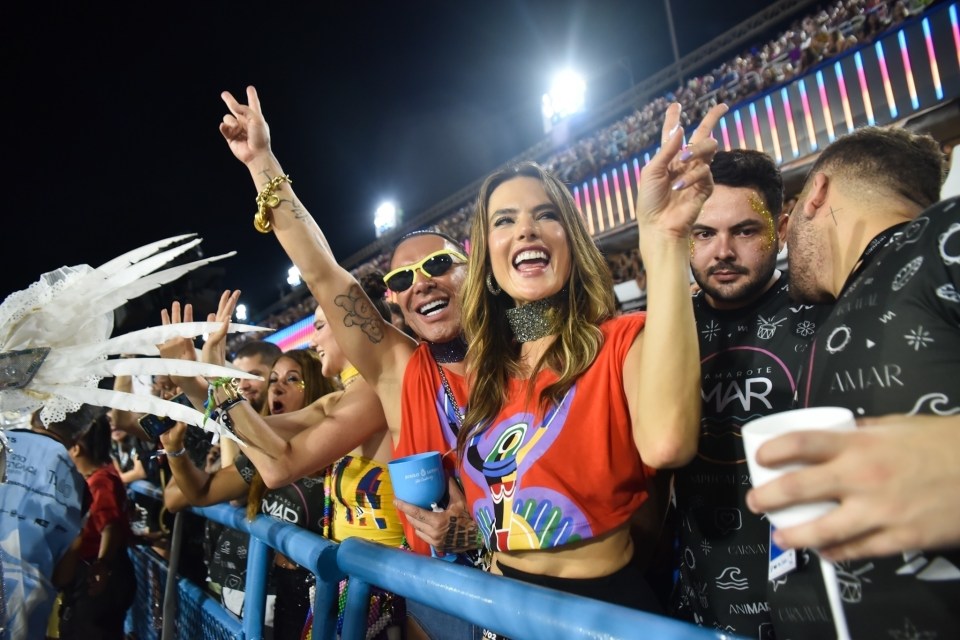 The model gave a peace sign as she joined millions who lined the streets in colourful outfits