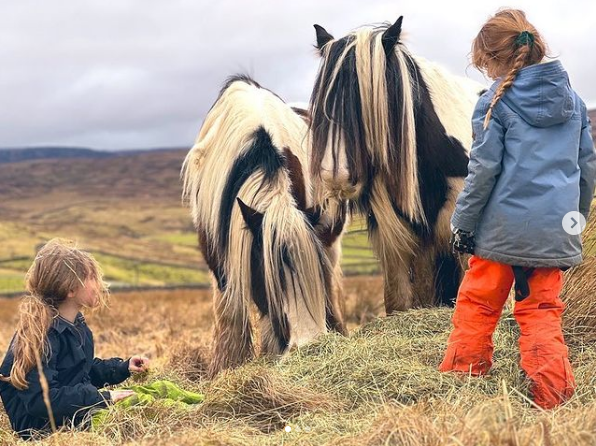 She shared adorable snaps of her young daughters tending to horses