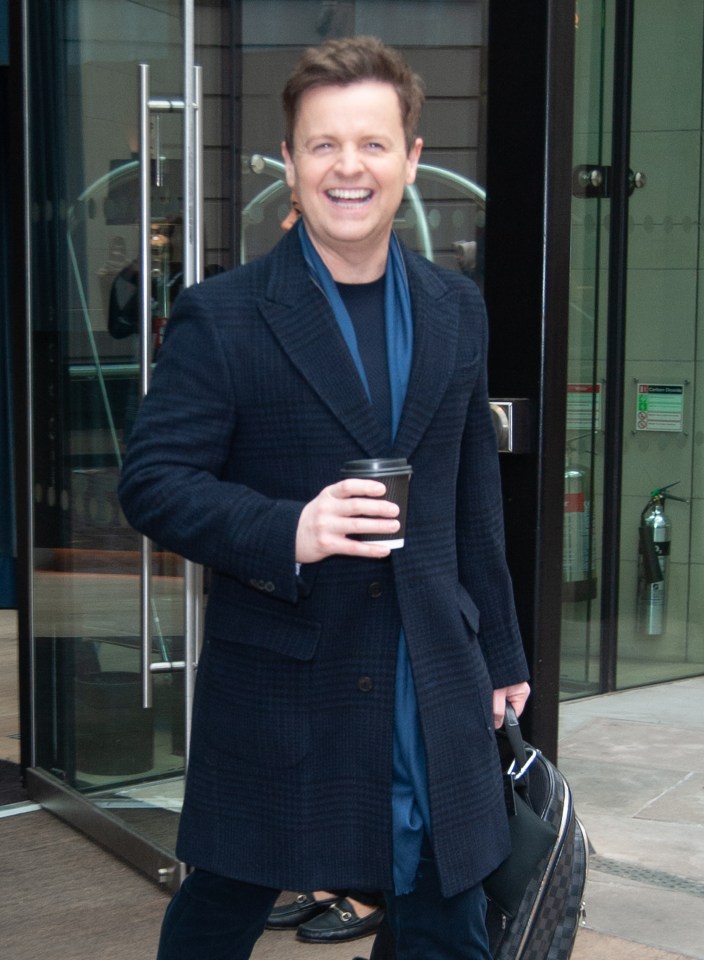 Dec looked delighted as he clutched his bag and coffee