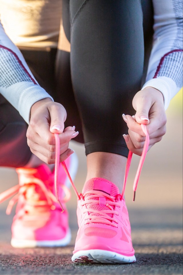 Woman tying shoelaces before a jog.