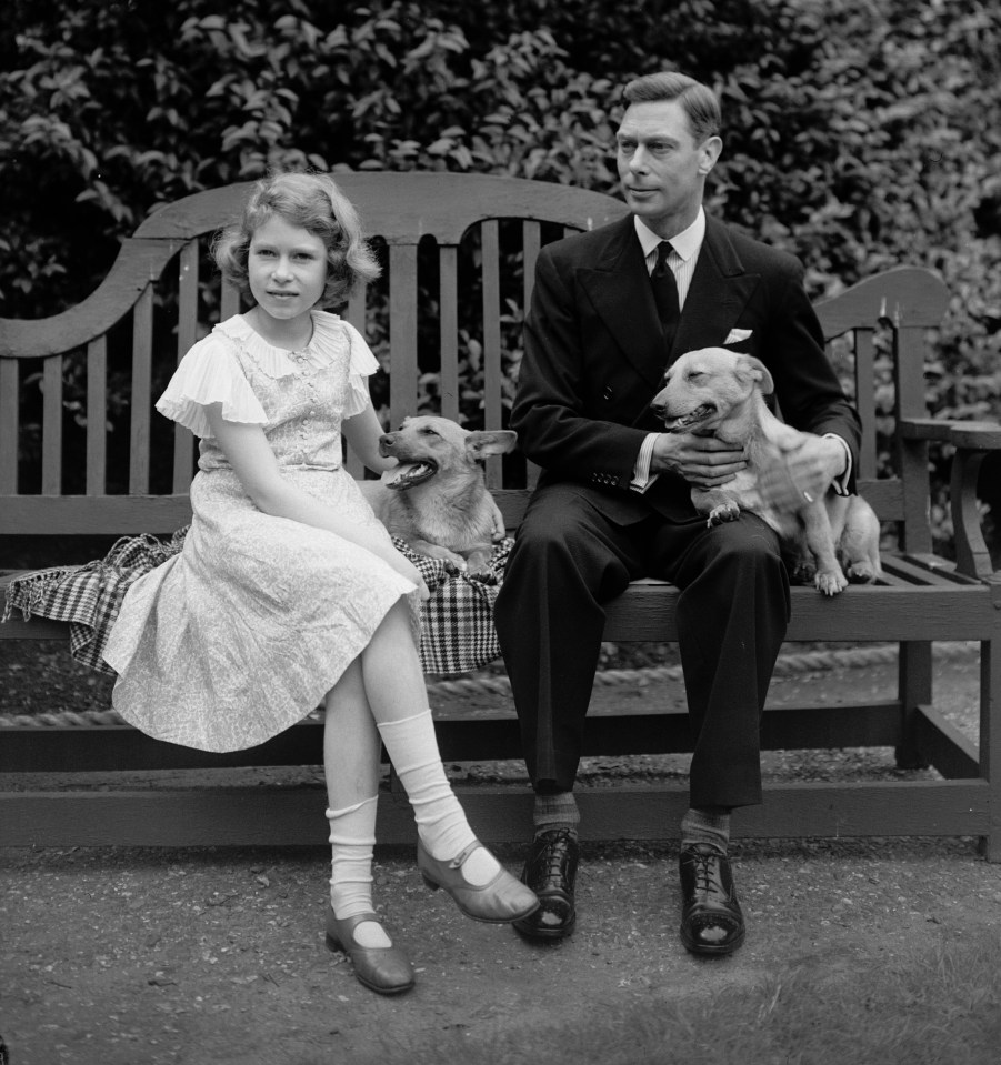 Elizabeth with her father and their pets in the garden of their home in 1930