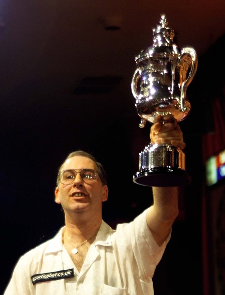 John Walton holds up the World Darts Champions cup after beating England’s Ted Hankey in the finals of the darts World championships, 2001