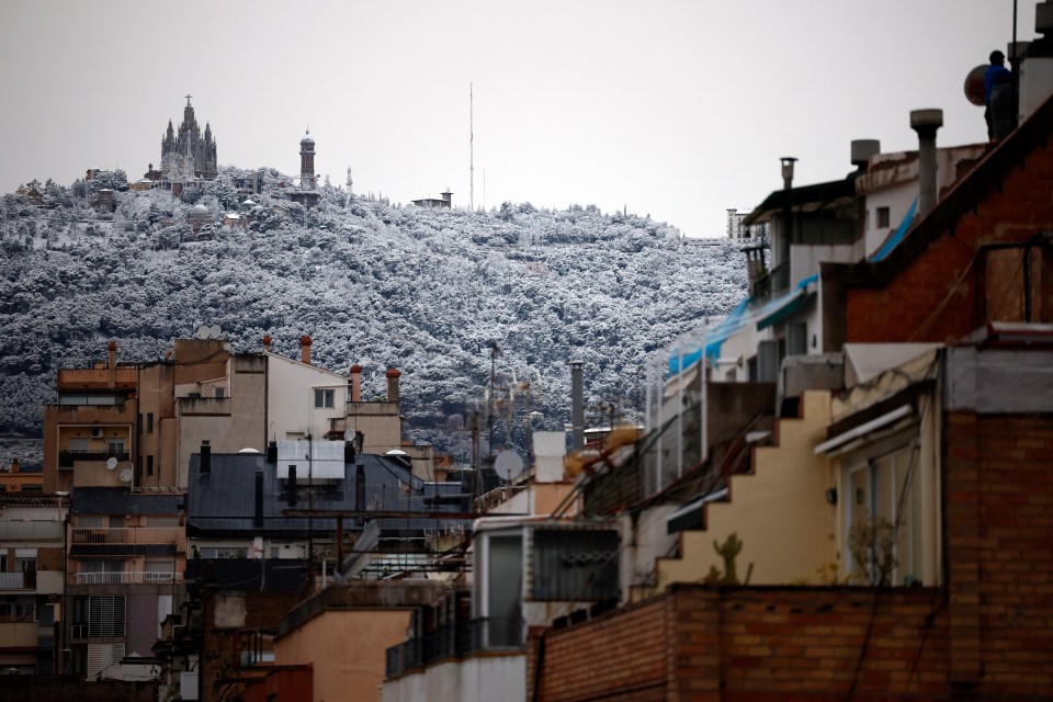 epa10493447 View of Tibidabo Hill covered in snow in Barcelona, Spain, 27 February 2023. EPA/Alejandro Garcia