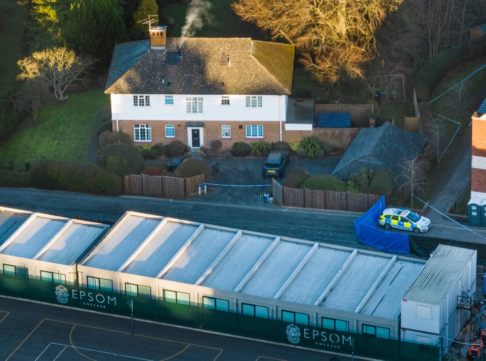 Police guard a cordon placed at a residential property on the school grounds