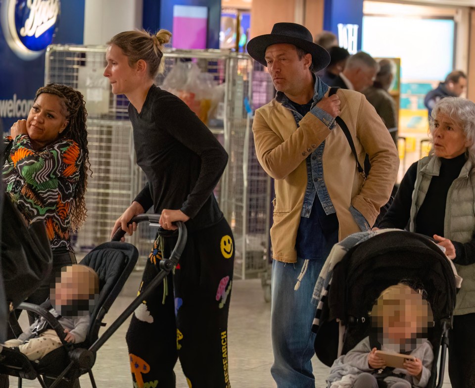 Jude Law and his wife Phillipa Coan at Heathrow with children