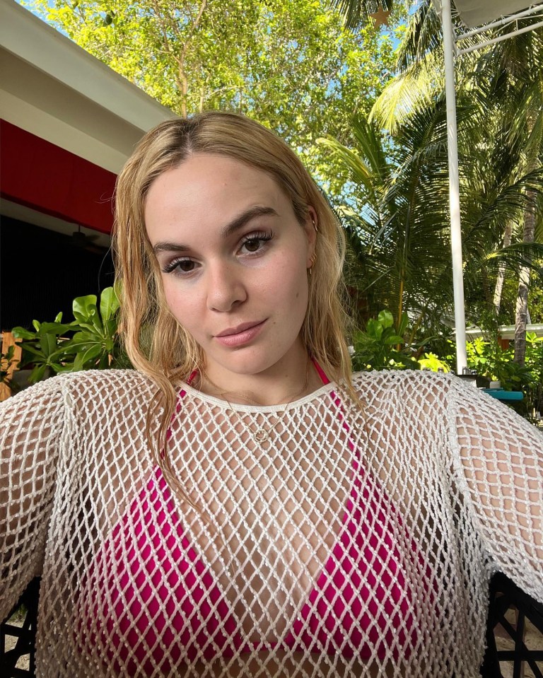 The 21 and Over podcast host, 23, also showed off her beach style in a nude fishnet cover-up