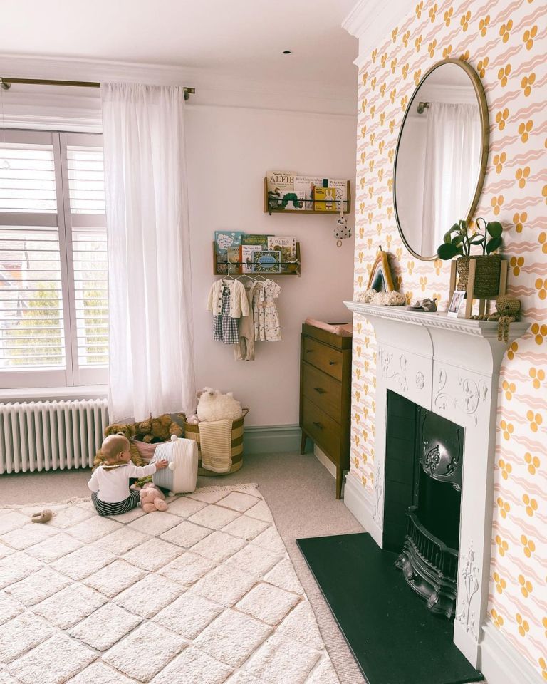 The tot, aged one, can be seen playing on a super-snug rug