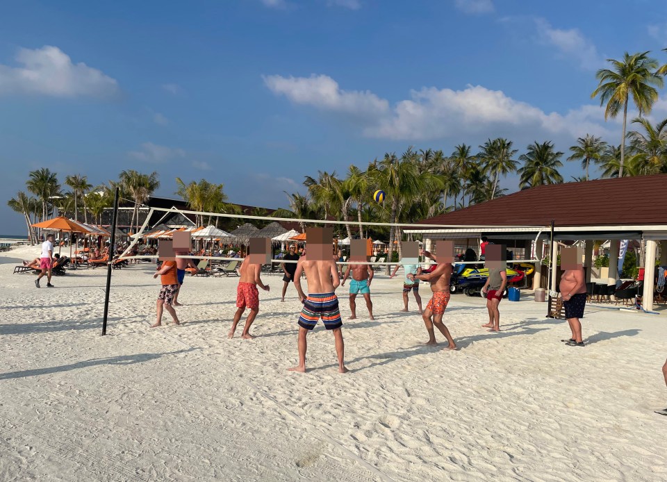 Lucky agents play volleyball while their partners bask on sun loungers