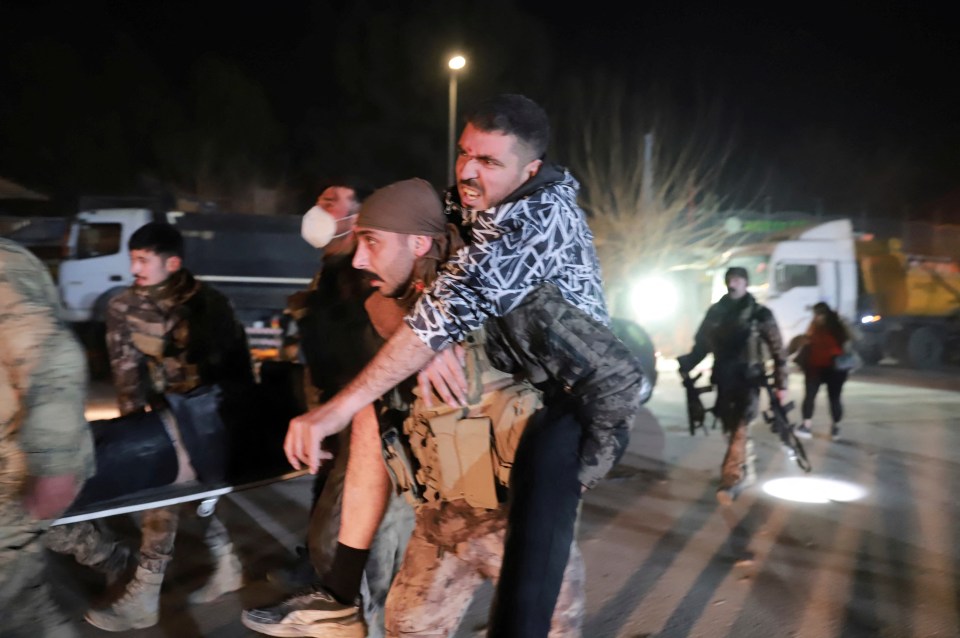 A member of Turkish police special forces carries a wounded man