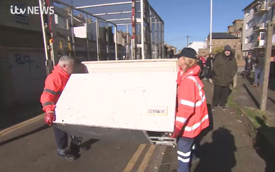 Contractors carry away the freezer after ruining the Banksy mural