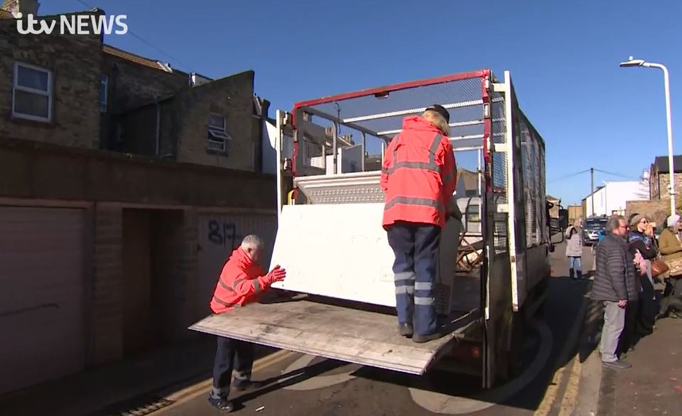 The freezer is shoved onto a council lorry