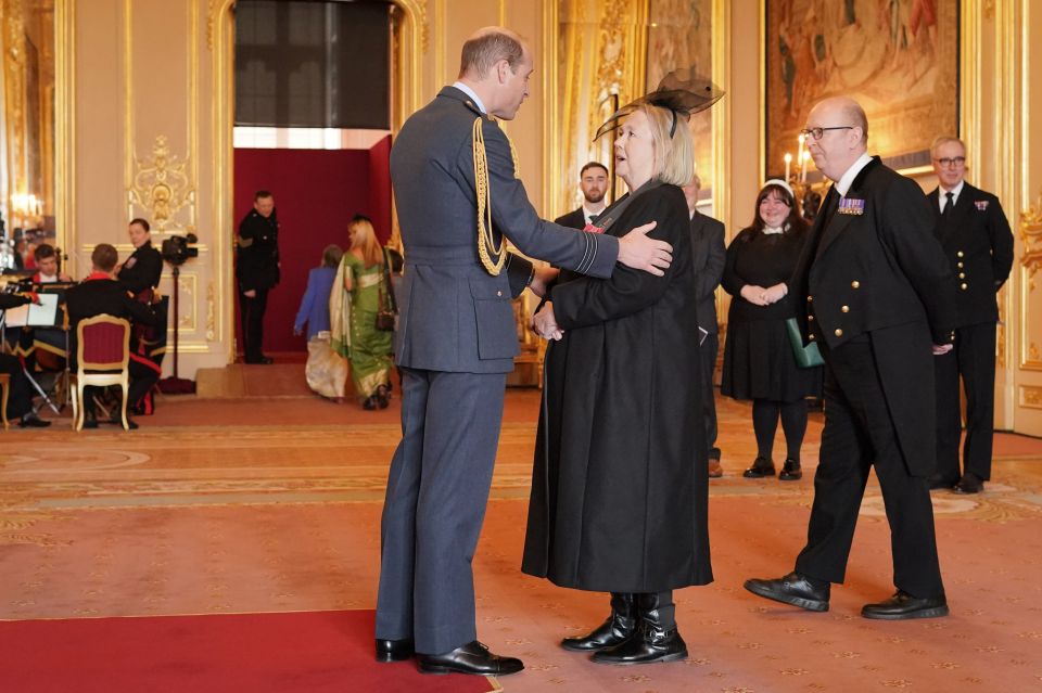 The Prince of Wales placed an arm on her shoulder to congratulate her