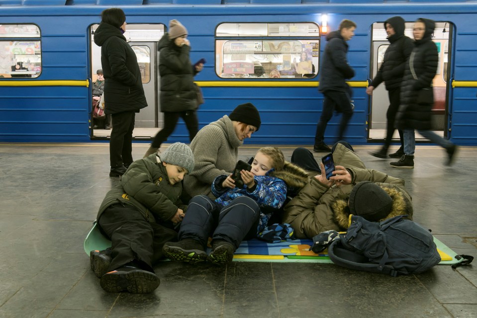 People take shelter inside a metro station during massive Russian missile attacks in Kyiv