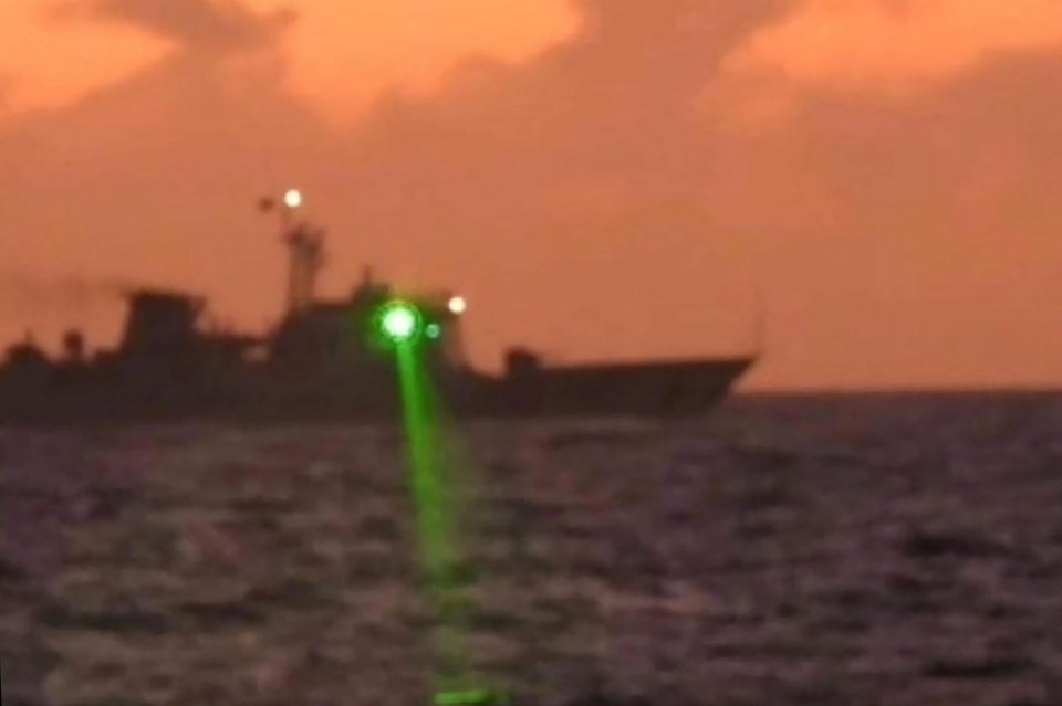 A picture showing the Chinese warship shining its laser