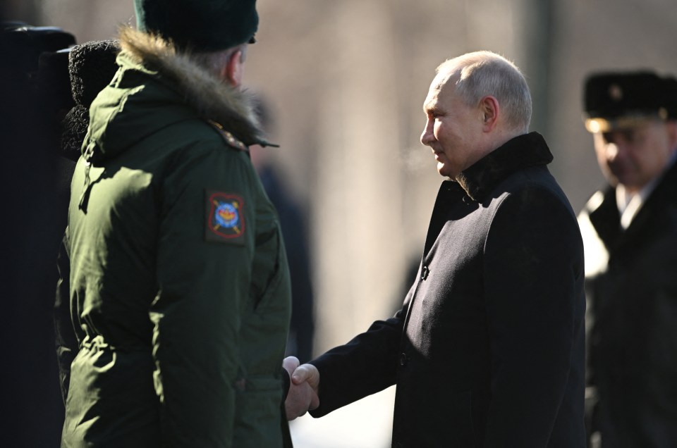 He shook hands with members of Russia's armed forces