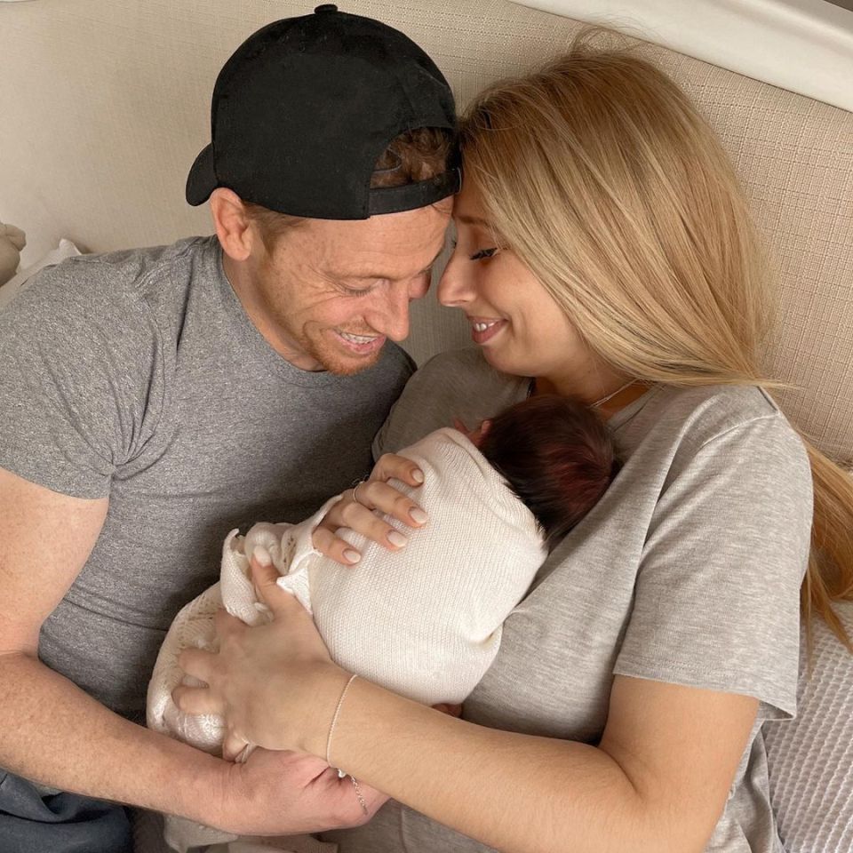 Stacey and husband Joe Swash cradle their new daughter