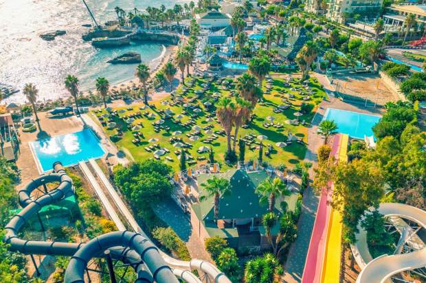 an aerial view of a water park with a pirate ship in the background