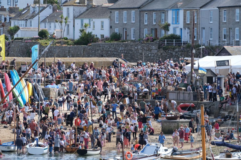 A beach in Mousehole is seen packed with visitors