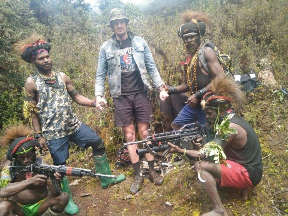 The Papuan separatist rebels pose for a photo with their hostage