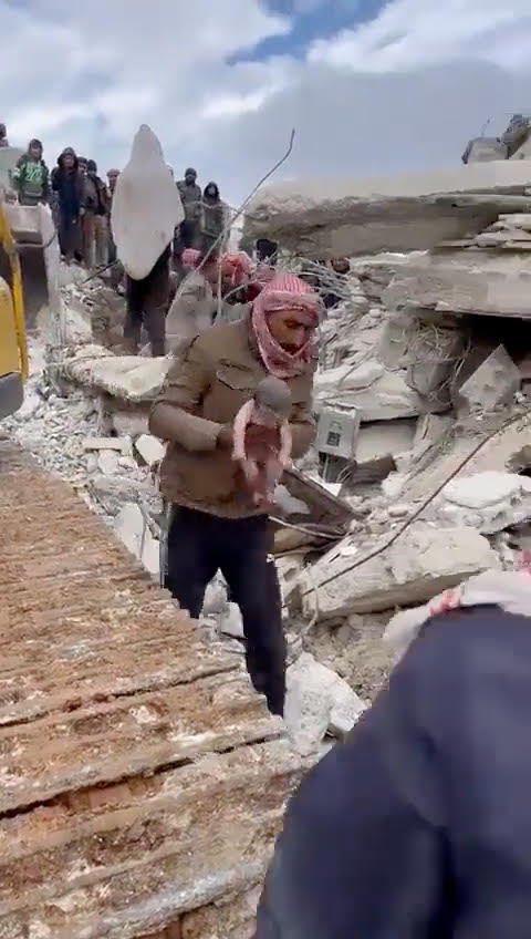 She was born under the rubble before being rescued by brave locals