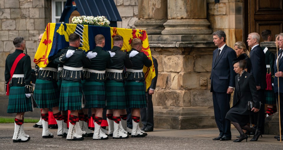 Princess Anne curtsies as her mother's coffin is carried into Holyroodhouse