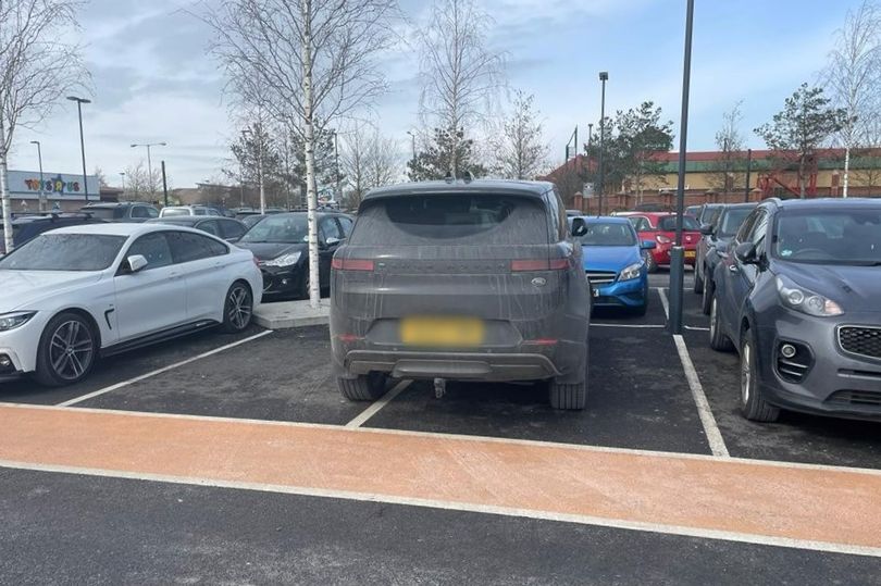 A furious woman snapped the 4x4 Range Rover occupying two parking bays