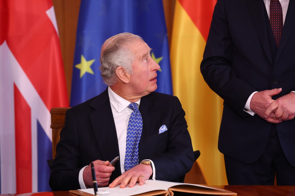 Charles signs the official guest book at Schloss Bellevue